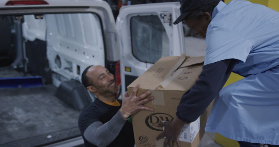 MTCC Difference_employee passing box to charity volunteer0